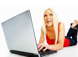Casual girl browsing on a laptop isolated over white